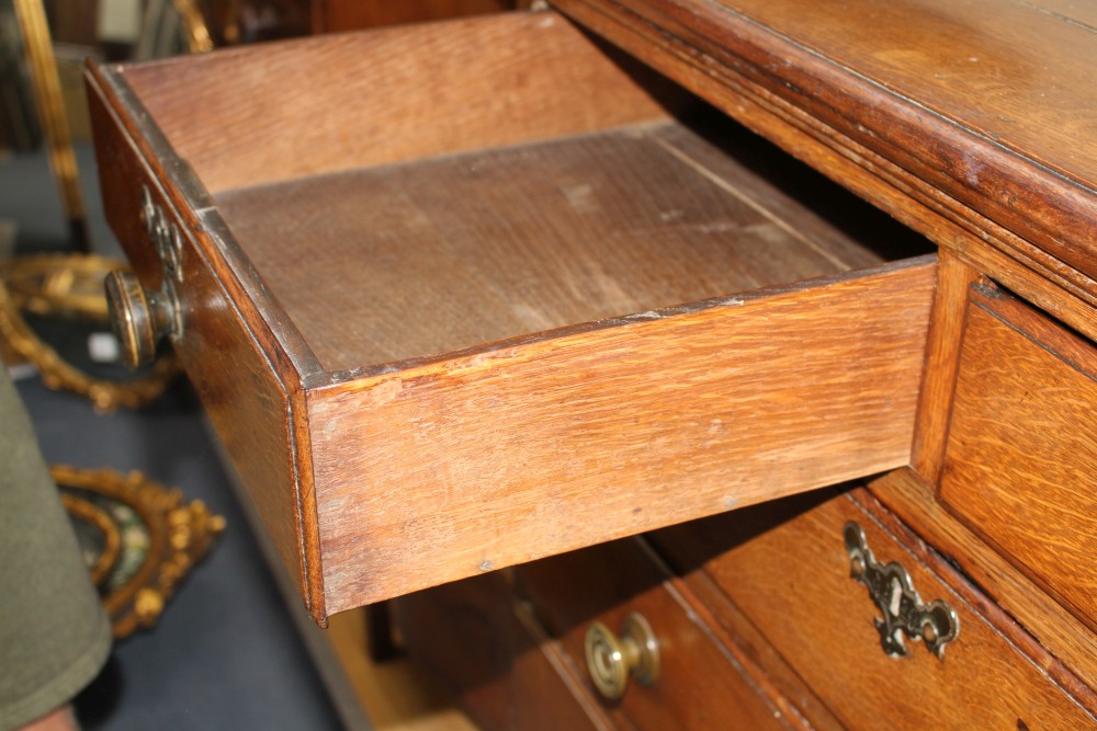 A 19th century panelled oak chest of drawers, W.103cm D.56cm H.112cm